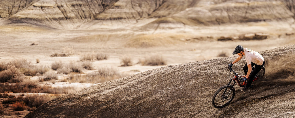 Guerilla Gravity mountain biker riding loose dirt in the desert