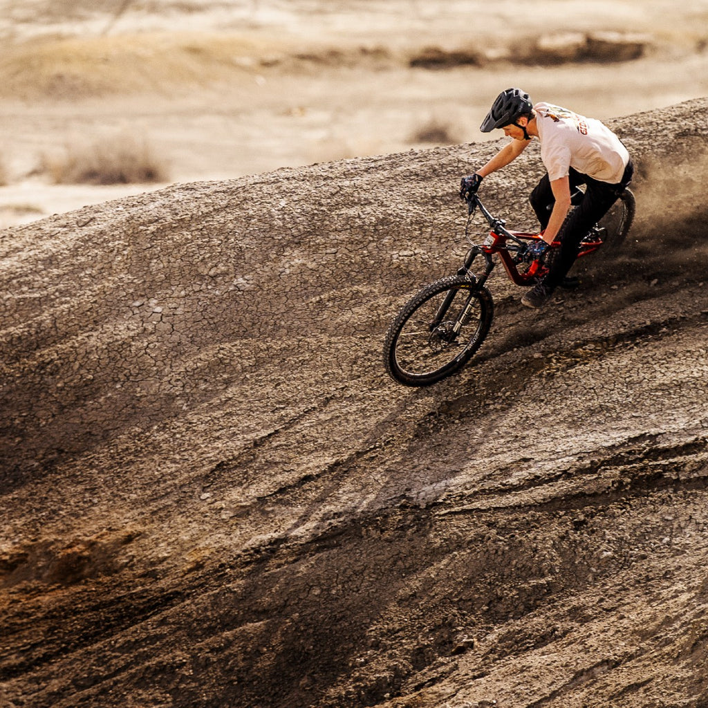 Guerilla Gravity mountain biker riding loose dirt in the desert mobile view